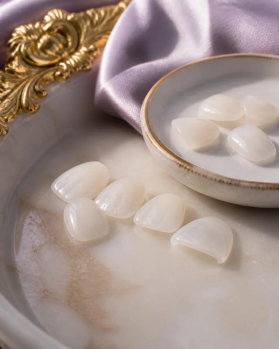 Porcelain veneers displayed on a marble tray